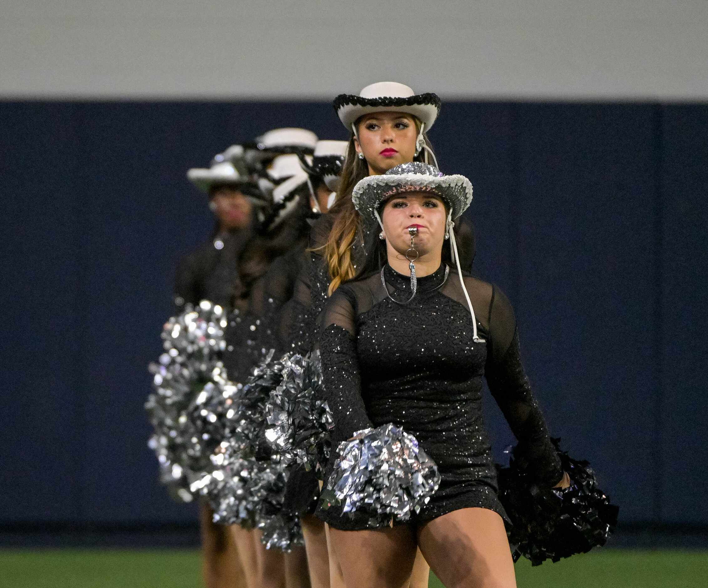 The Panther Creek drill team matches on the field befor a high school football game between ...