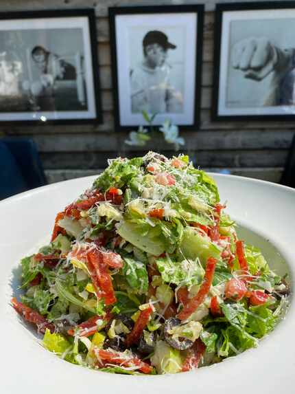The chopped salad at Pizza Parm Project is tossed with pepperoncinis, pepperoni cracklins...
