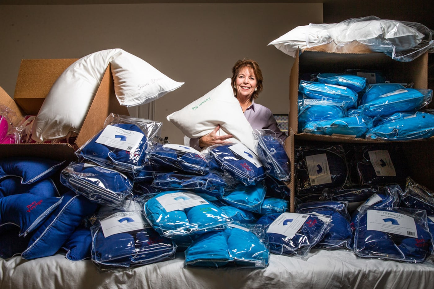 Merrimac Dillon poses with her pillows at the Pillow Bar. The store's Jetsetter Mini Pillow...