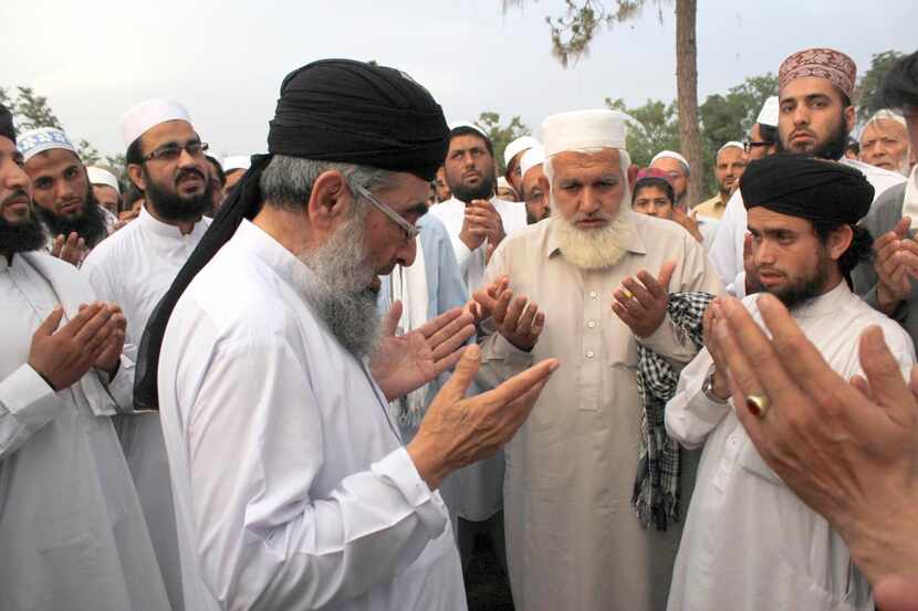
At a service held by about 50 Islamists in Peshawar, Pakistan, people offered prayers...