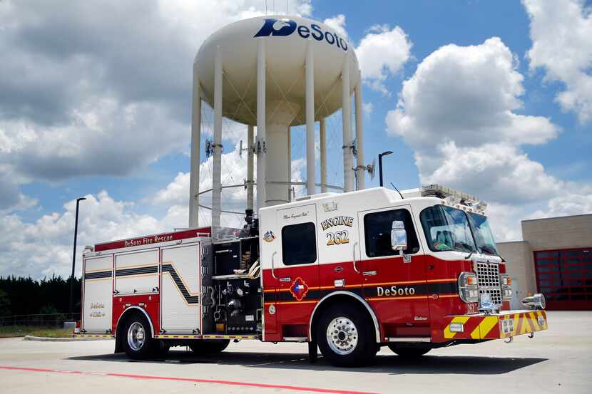 The DeSoto, Texas fire department's Engine 262 is pictured with a city water tower,...