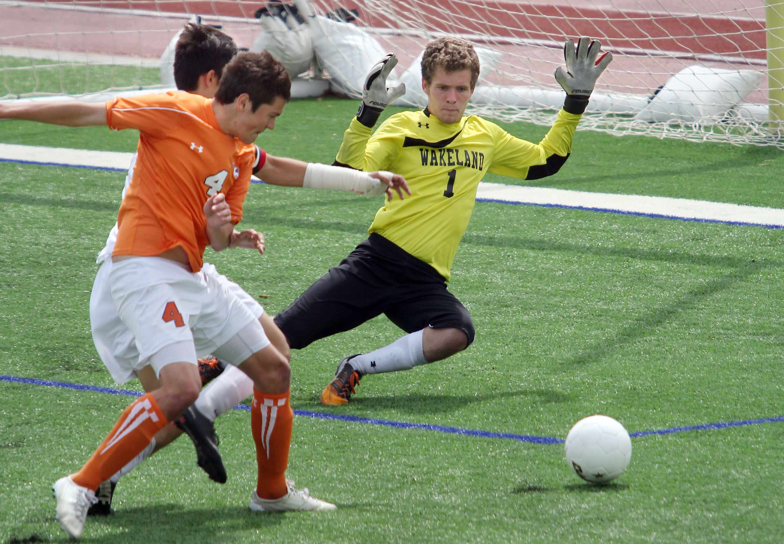Frisco Wakeland's Taylor Brown (4, left) and goalkeeper Sam Whaley (1, right)) successfully...