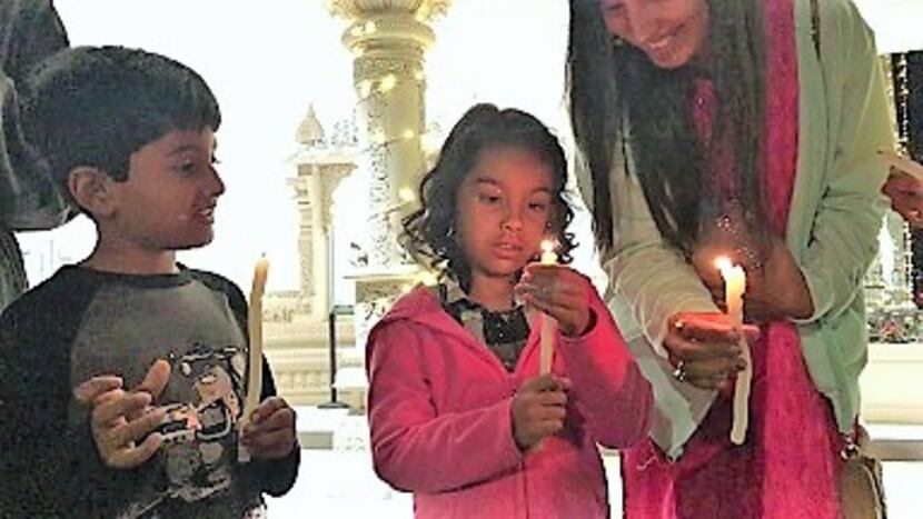 Children participate in the Candlelight Circle of Gratitude at Radha Krishna Temple in Allen.