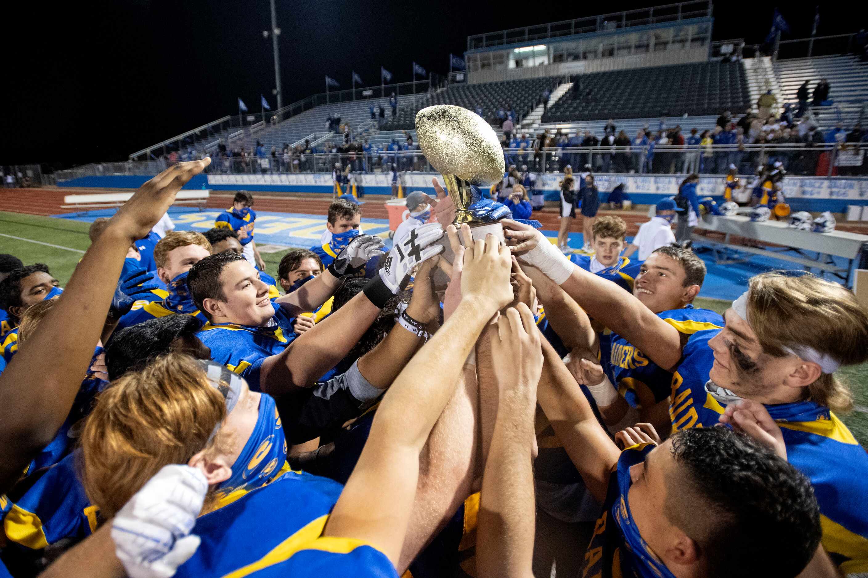 Sunnyvale players hoist the trophy after beting Ferris 38-14 in a bi-district round playoff...