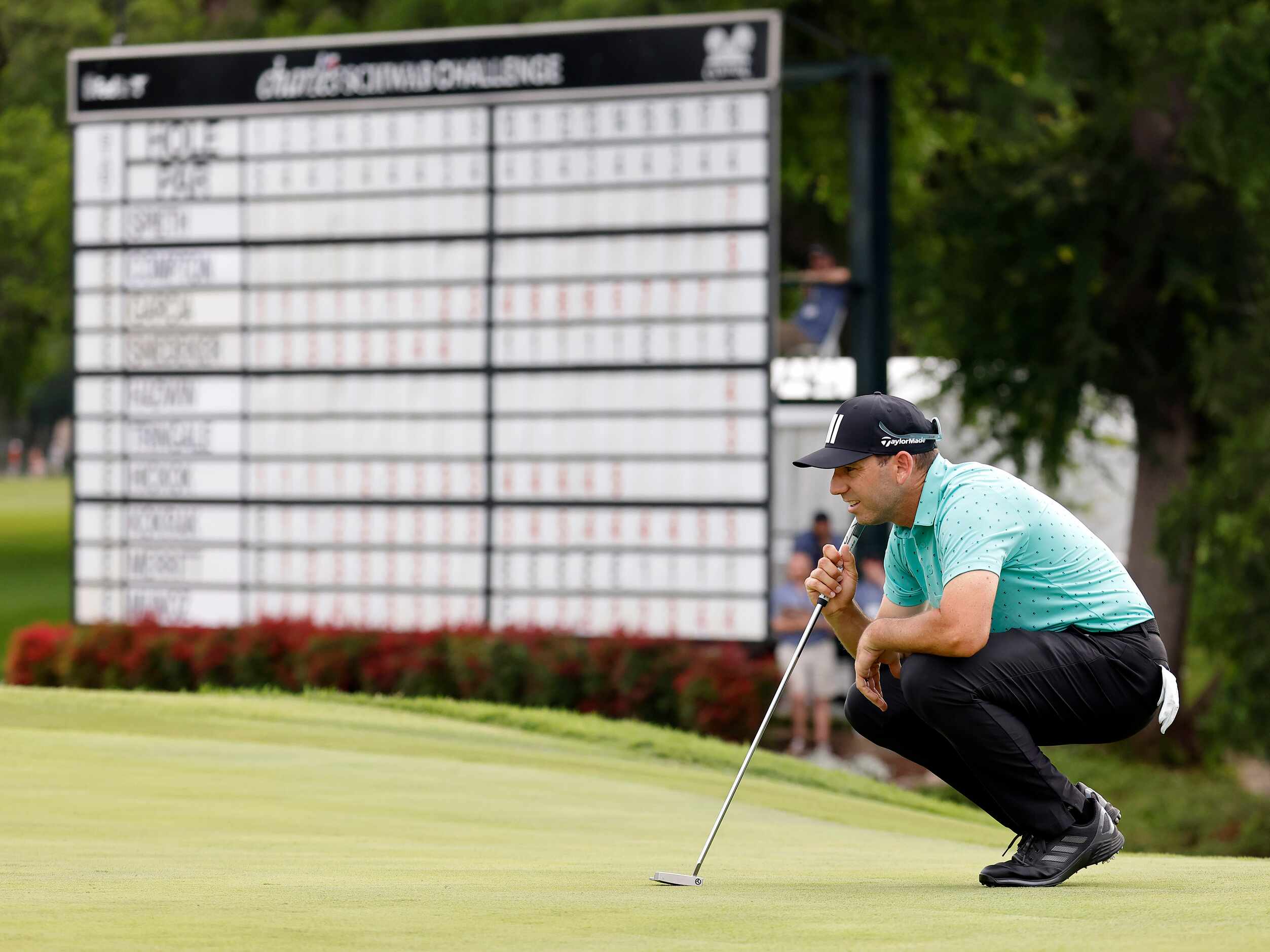 Professional golfer Sergio Garcia eyes the No. 18 green before putting during round one of...