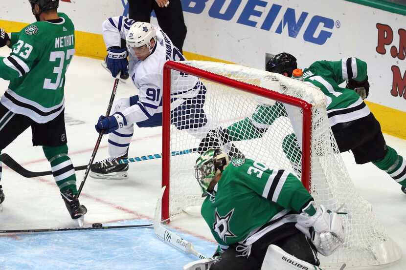 Toronto Maple Leafs center John Tavares (91) comes from behind the goal to take a shot...