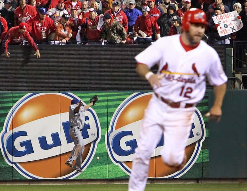 St. Louis Cardinals fans react as Texas Rangers right fielder Nelson Cruz can't come up with...