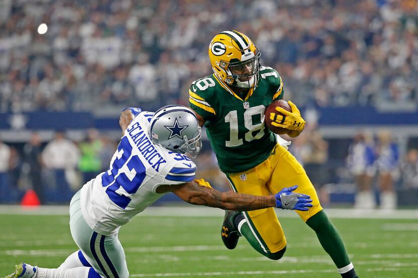 Green Bay Packers wide receiver Randall Cobb (18) is tackled by Dallas Cowboys cornerback...