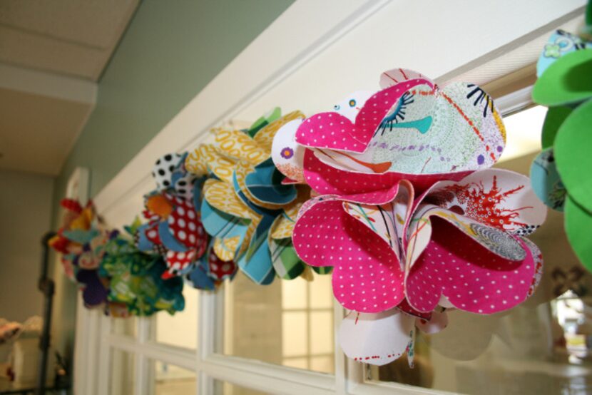 Colorful bunting made from fabric scraps adorn windows in Urban Spools. When Kitto opened at...