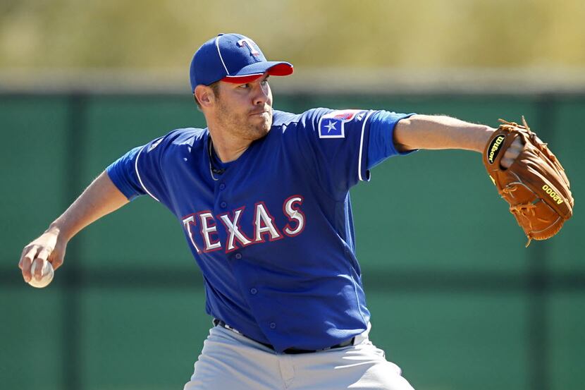Texas Rangers pitcher Colby Lewis pitches during the first inning of their inter-squad game...