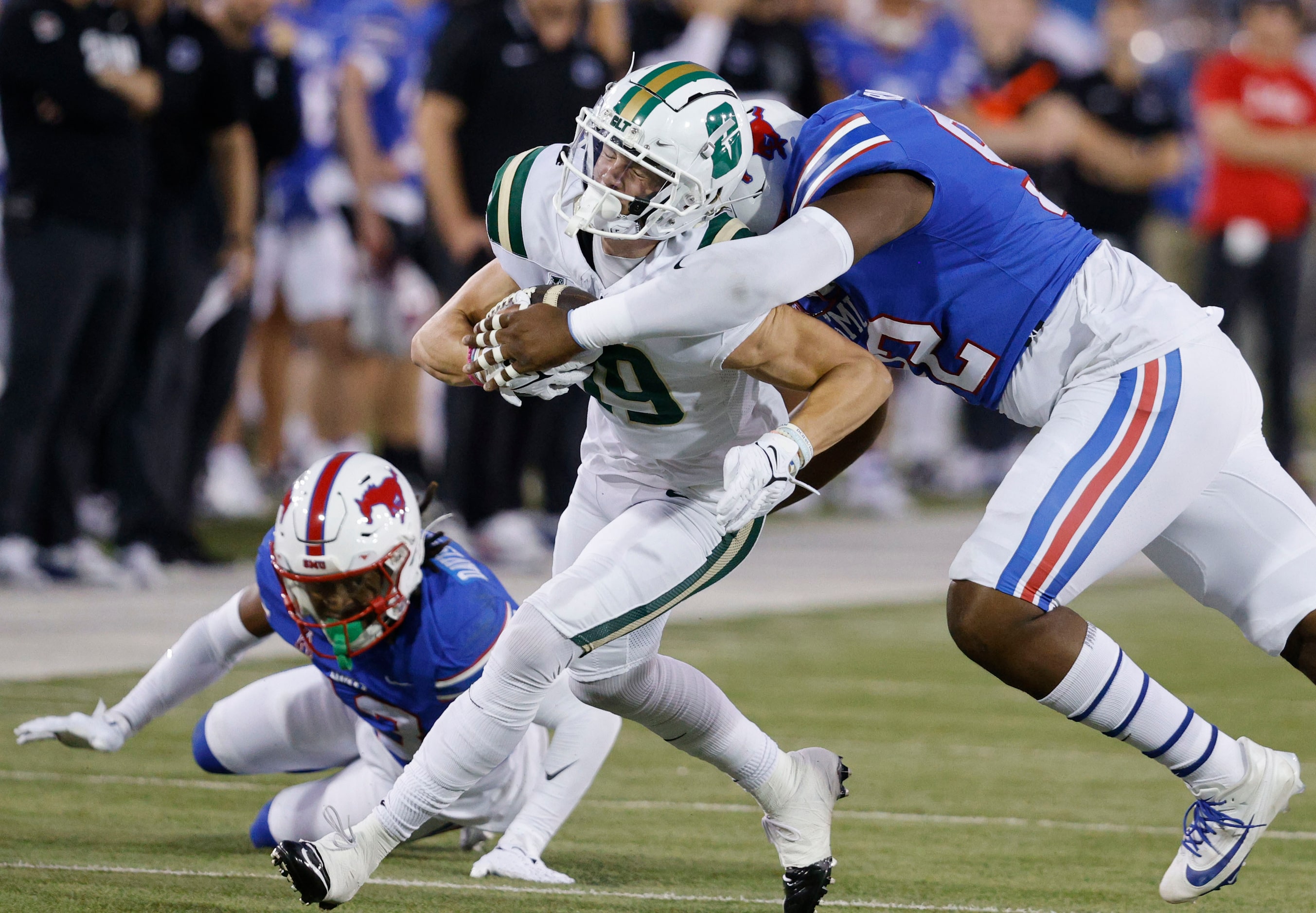 Charlotte 49ers wide receiver Jack Hestera (19) is tackled by SMU defensive tackle Kori...