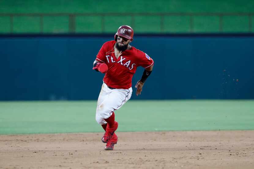 Texas Rangers' Rougned Odor sprints to third during a baseball game against the Cleveland...