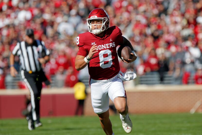 Oklahoma quarterback Dillon Gabriel carries the ball in the first half of an NCAA college...