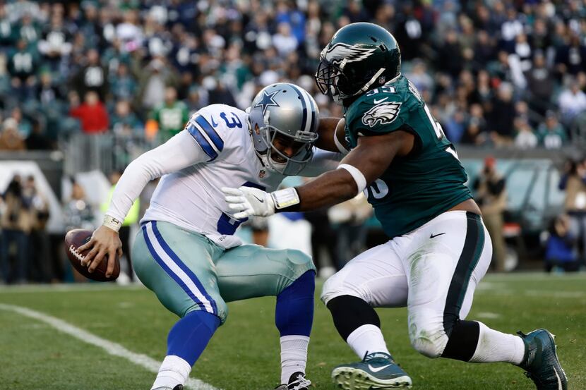 Dallas Cowboys' Mark Sanchez under pressure during the second half of an NFL football game...