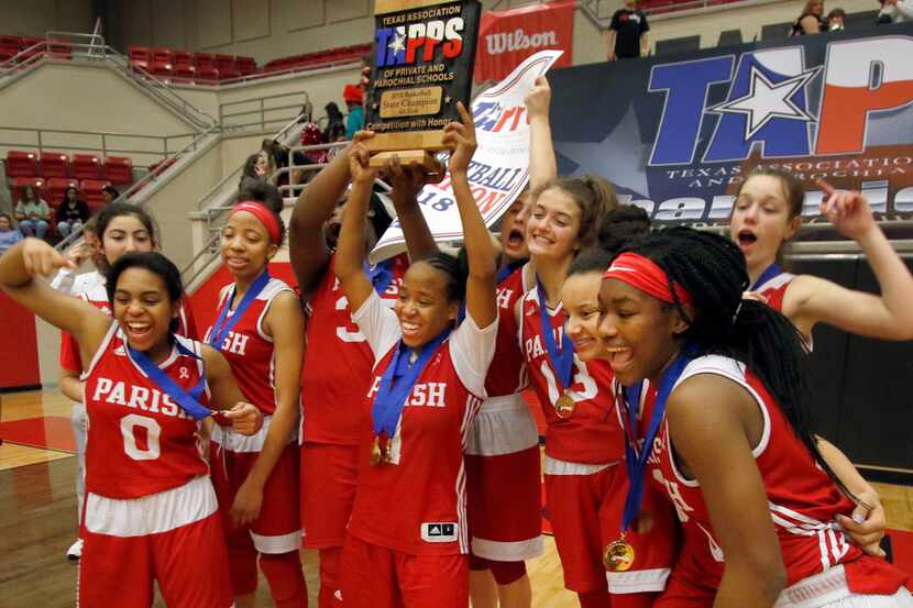 Parish Episcopal School sophomore guard Nevaeh Tot (1) raises the state championship trophy...