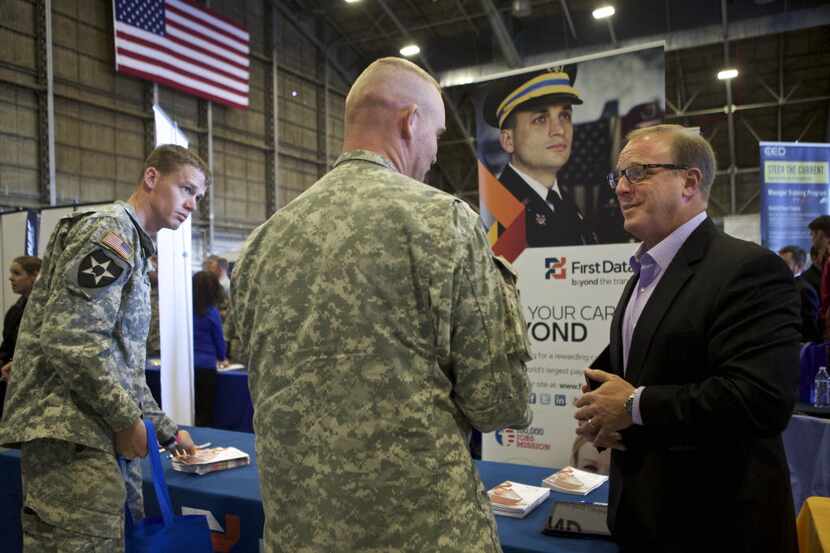 James Perduto (right), vice president of military employment of First Data Corp., talks with...