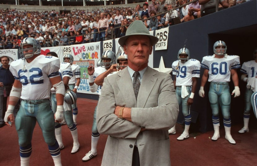 Dallas Cowboys coach Tom Landry waits at the tunnel entrance with the players before a game...