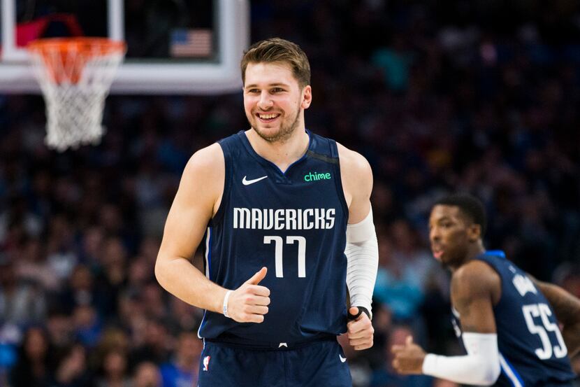 FILE - Mavericks guard Luka Doncic (77) smiles during the first quarter of a game against...