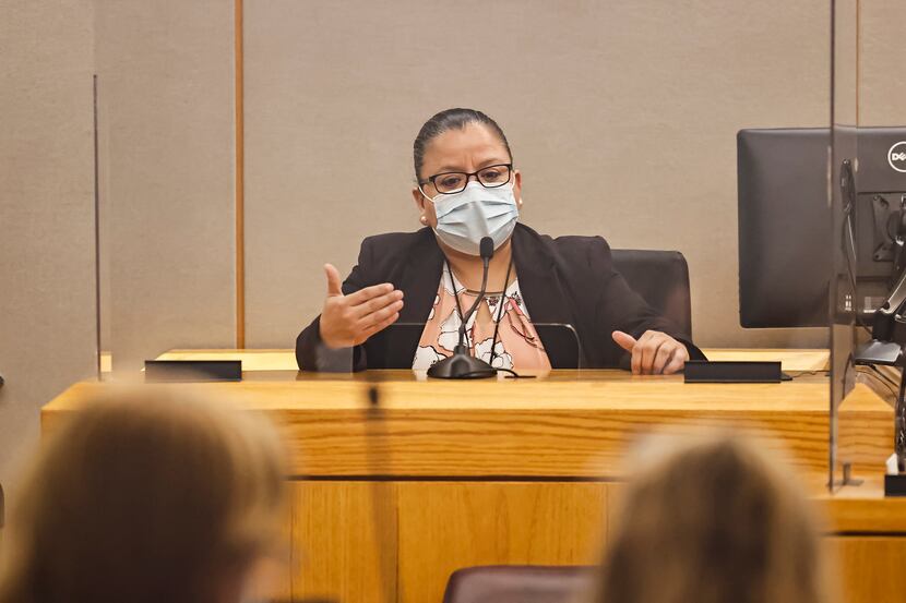 Dallas Police Detective Christine Ramirez talks on the stand during a hearing conducted by...