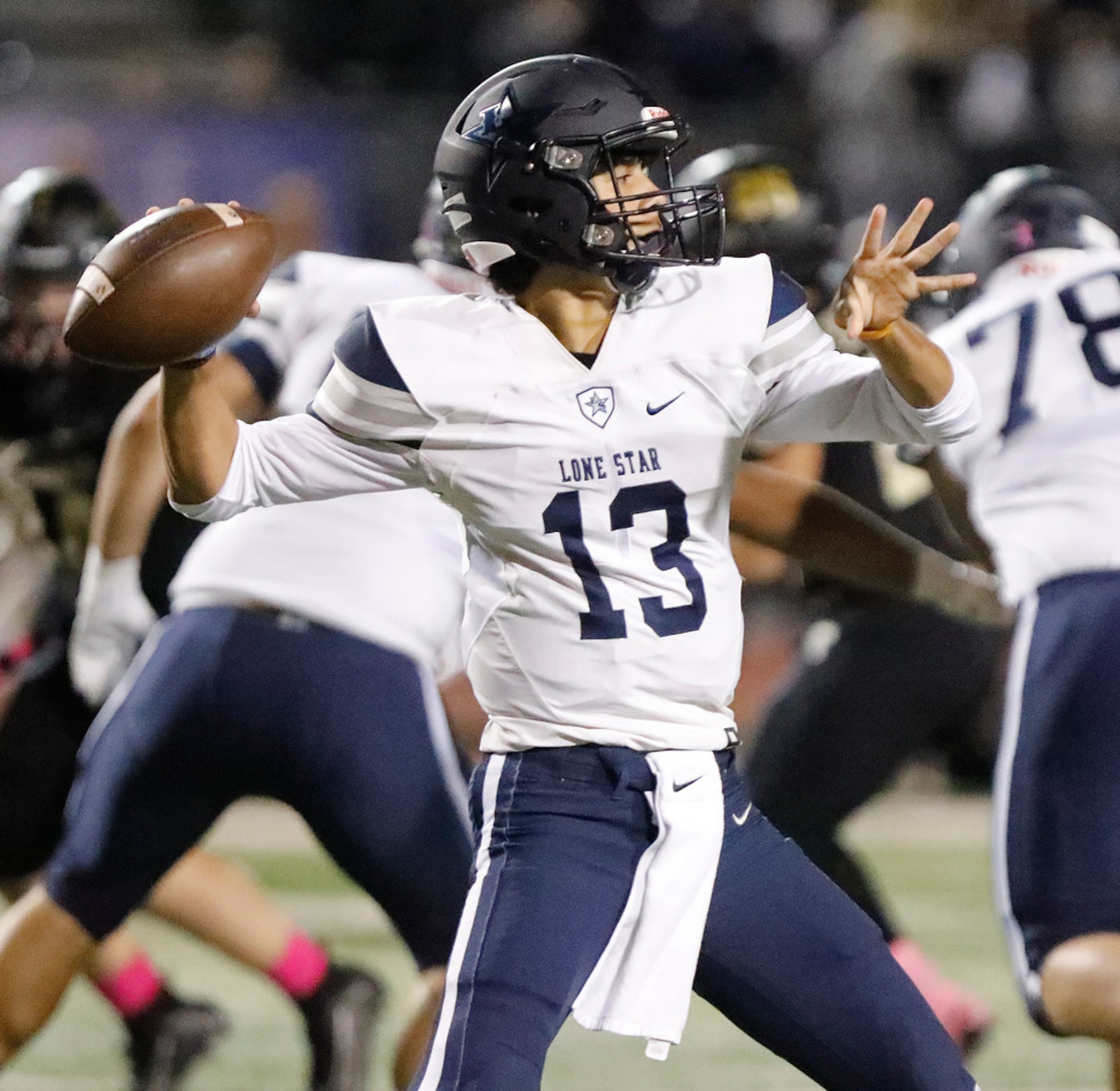 Lone Star High School quarterback Garret Rangel (13) throws a pass during the first half as...