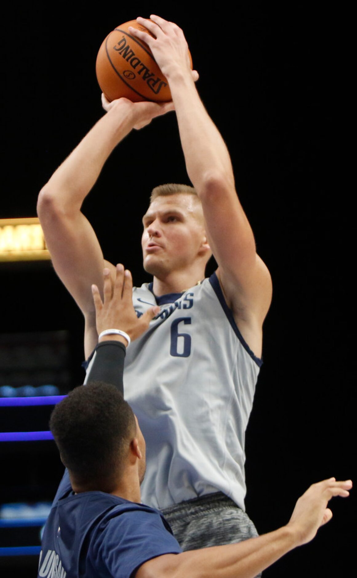 Dallas Mavericks center Kristaps Porzingis (6) scores on a jump shot over the defense of...