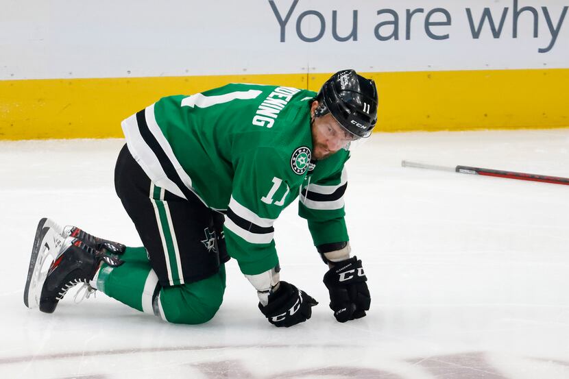 Dallas Stars center Luke Glendening (11) is slow to get to his feet after being hit by...