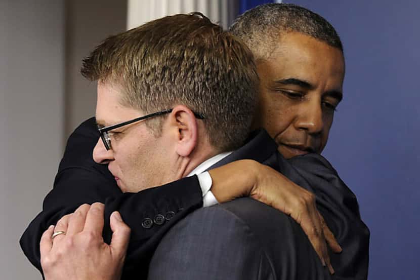 President Barack Obama hugs White House press secretary Jay Carney Friday after Obama
made a...