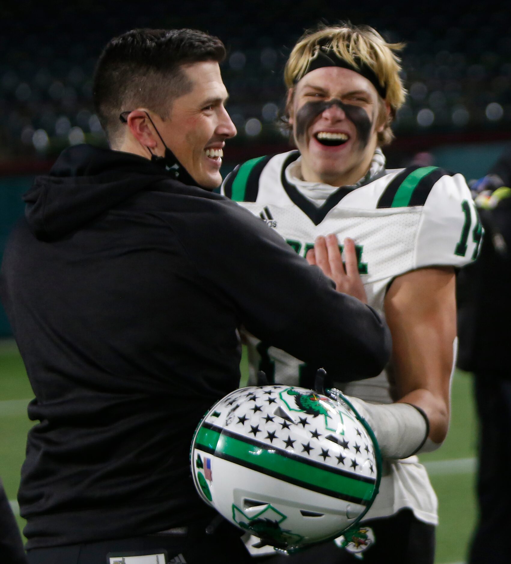 Southlake head coach Riley Dodge celebrates with Dragons receiver Brady Boyd (14) following...