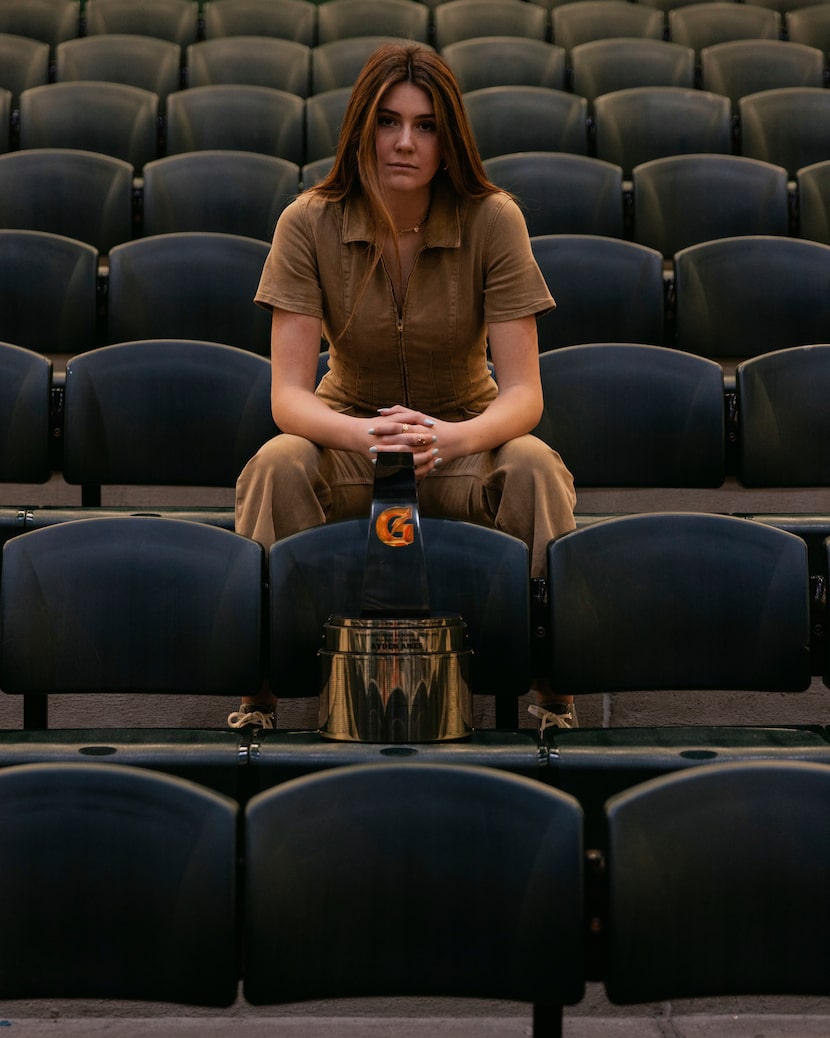 Prosper's Ayden Ames sits with the trophy she received for being the Gatorade National...