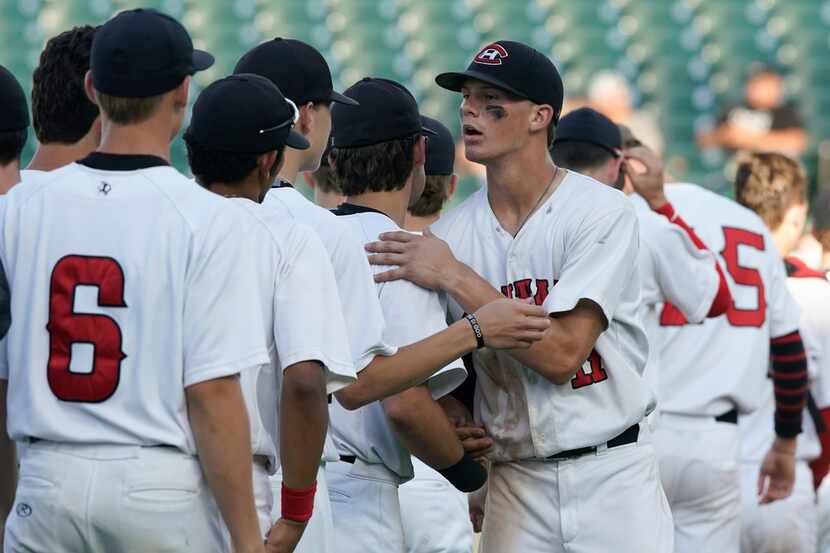 Colleyville Heritage's Bobby Witt (17 )congratulates his teamates after coming on in relief...
