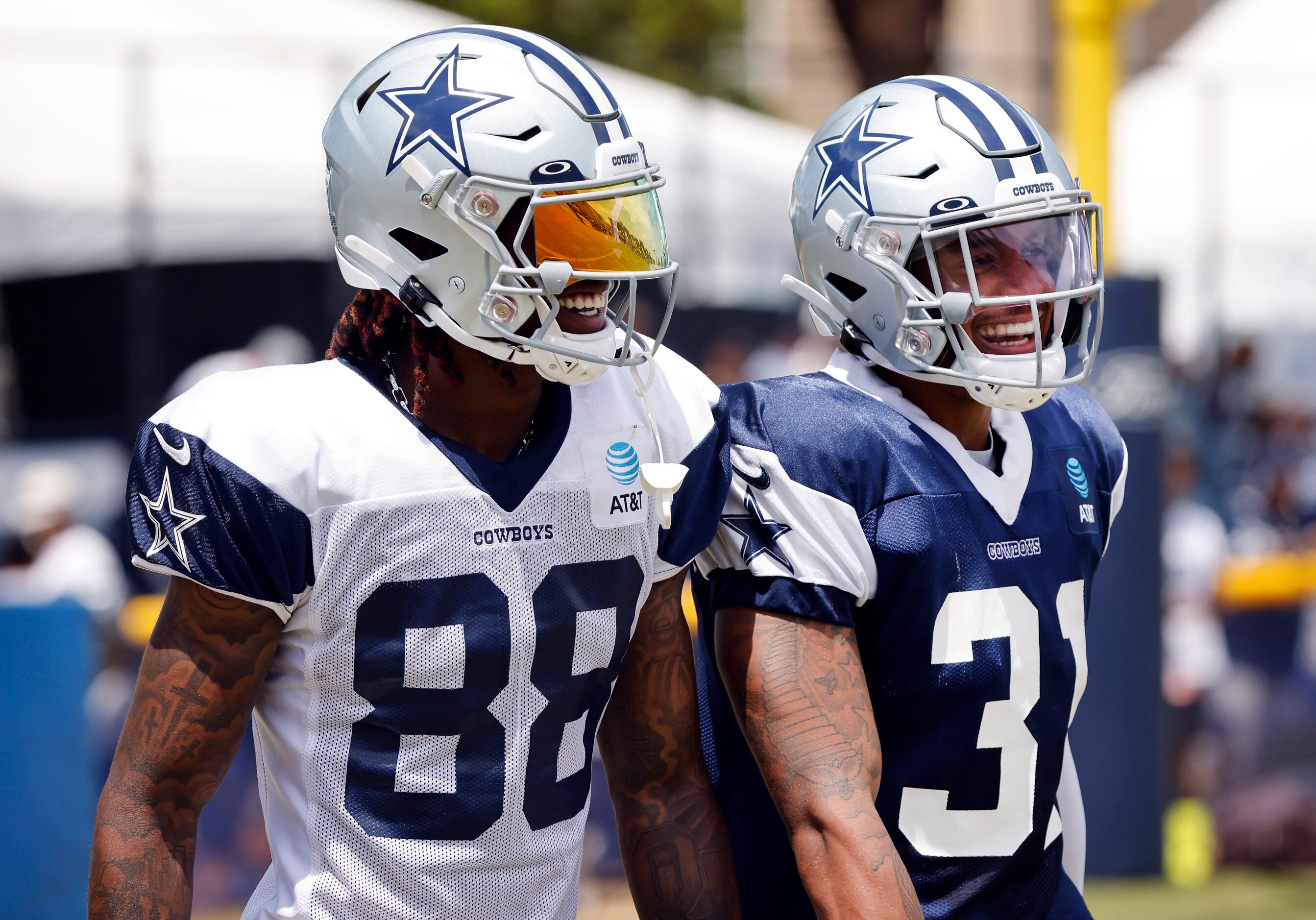 Dallas Cowboys wide receiver CeeDee Lamb (88) and  safety Tyler Coyle (31) laugh with one...