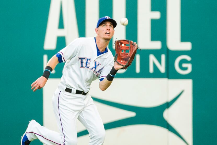 Texas Rangers center fielder Carlos Tocci (15) catches a fly ball in center field hit by...