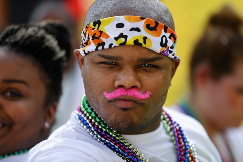 Armonte Terry of Irving shows off his pink mustache and beads as he watches the Alan Ross...