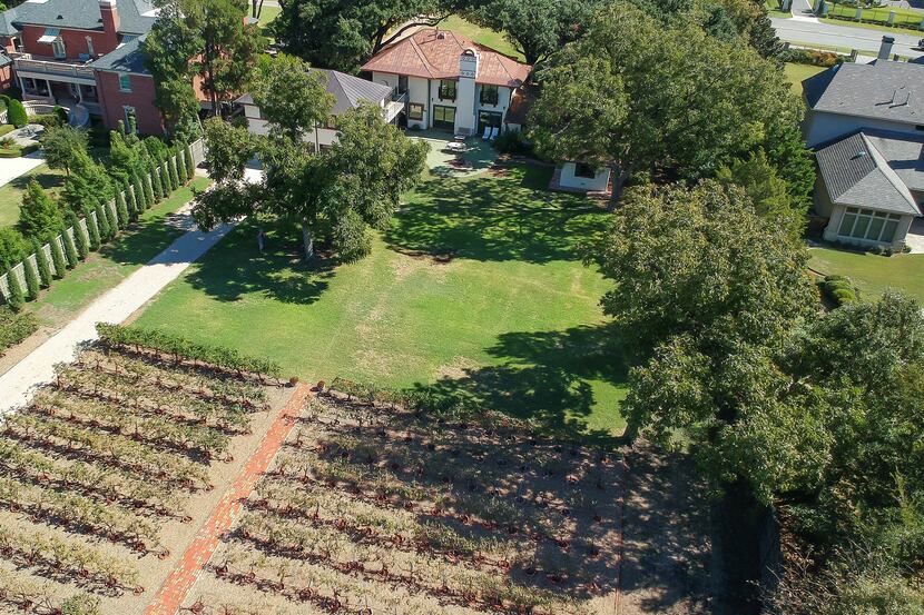 Homeowners can grow their own grapes in the backyard vineyard at 8123 Inwood Road, offered...