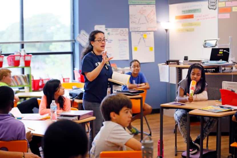 
Caroline Canessa teaches her fifth-grade English students in a new classroom at Merriman...
