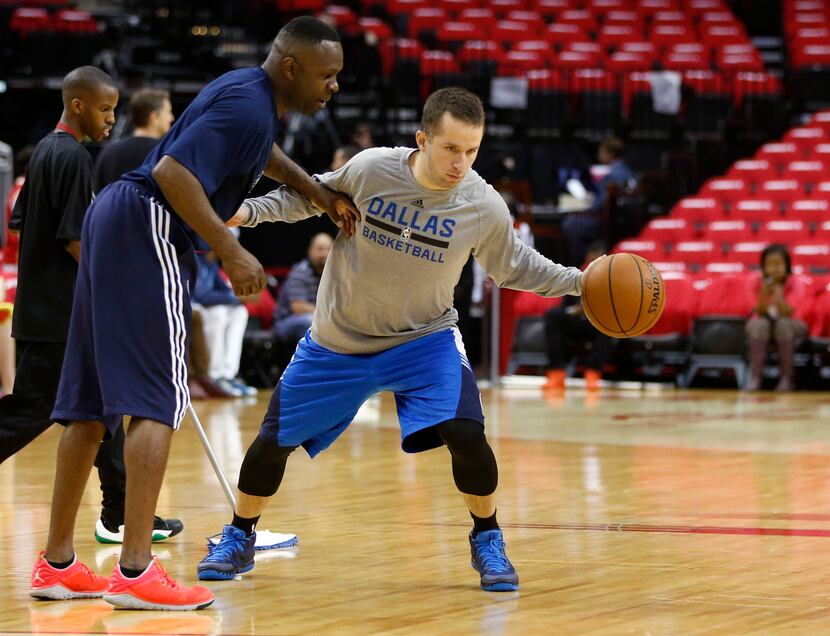Dallas Mavericks guard J.J. Barea (5) works out with assistant coach Darrell Armstrong...
