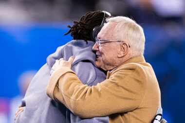 Dallas Cowboys Owner Jerry Jones hugs Dallas Cowboys defensive end Michael Bennett (79)...