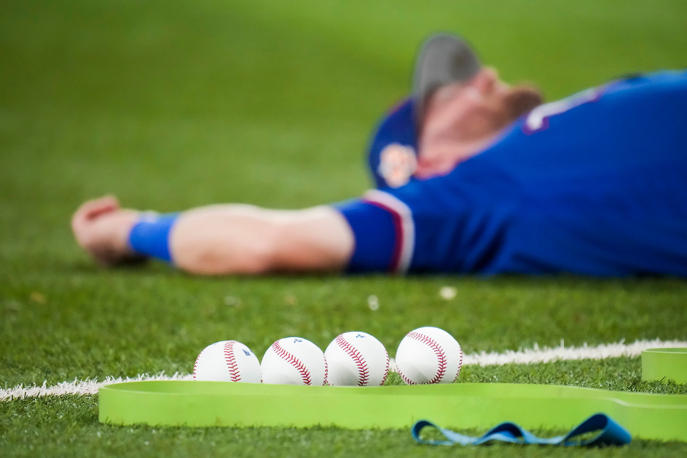 Texas Rangers outfielder Robbie Grossman stretches on the field before an exhibition...