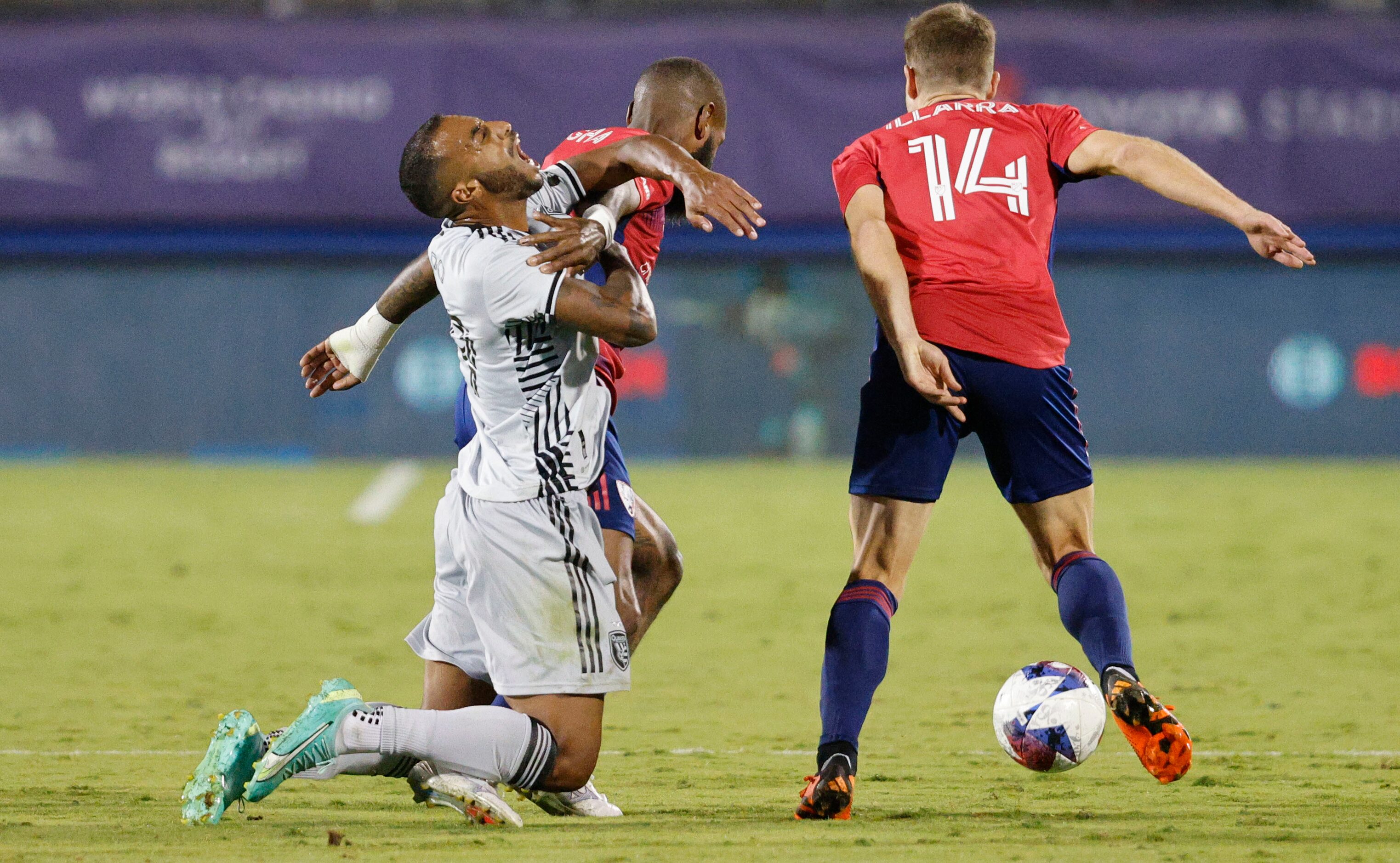 San Jose Earthquakes defender Carlos Akapo (29) tangles with FC Dallas defender Sebastien...