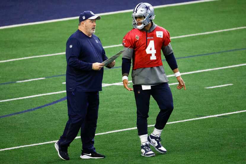 Dallas Cowboys head coach Mike McCarthy (left) talks to quarterback Dak Prescott (4) during...