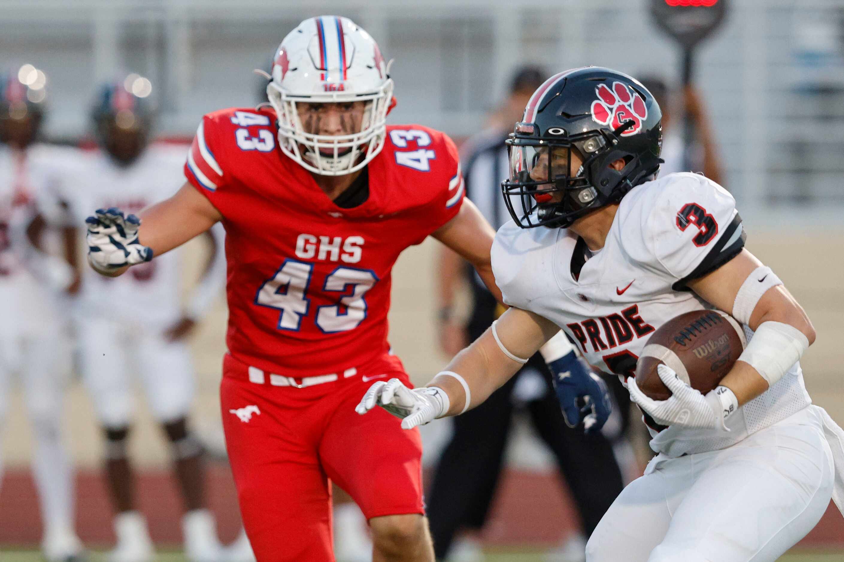 Colleyville Heritage's Ryan Keleher (3) carries the ball against Grapevine's Bradley Stanyer...