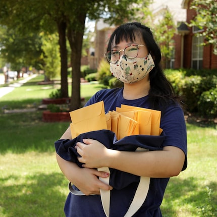 Susan Bin poses for a photograph with some packages ready to be mailed at her home in Plano...