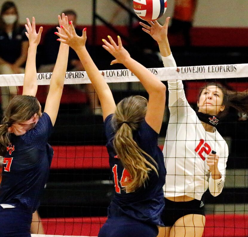 Lovejoy High School middle hitter Hannah Gonzalez (12) makes a hit during game two as...