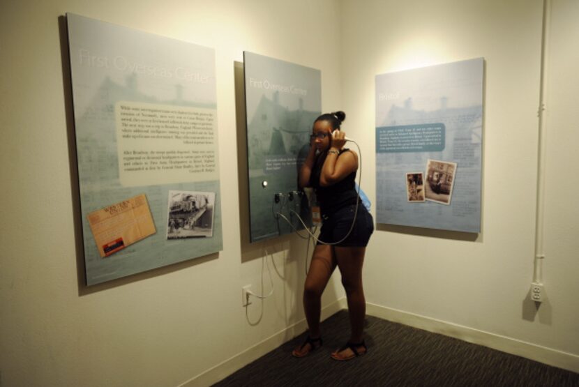 Maklia Slater, 13, a participant in the Thriving Minds summer camp, listens to audio in the...