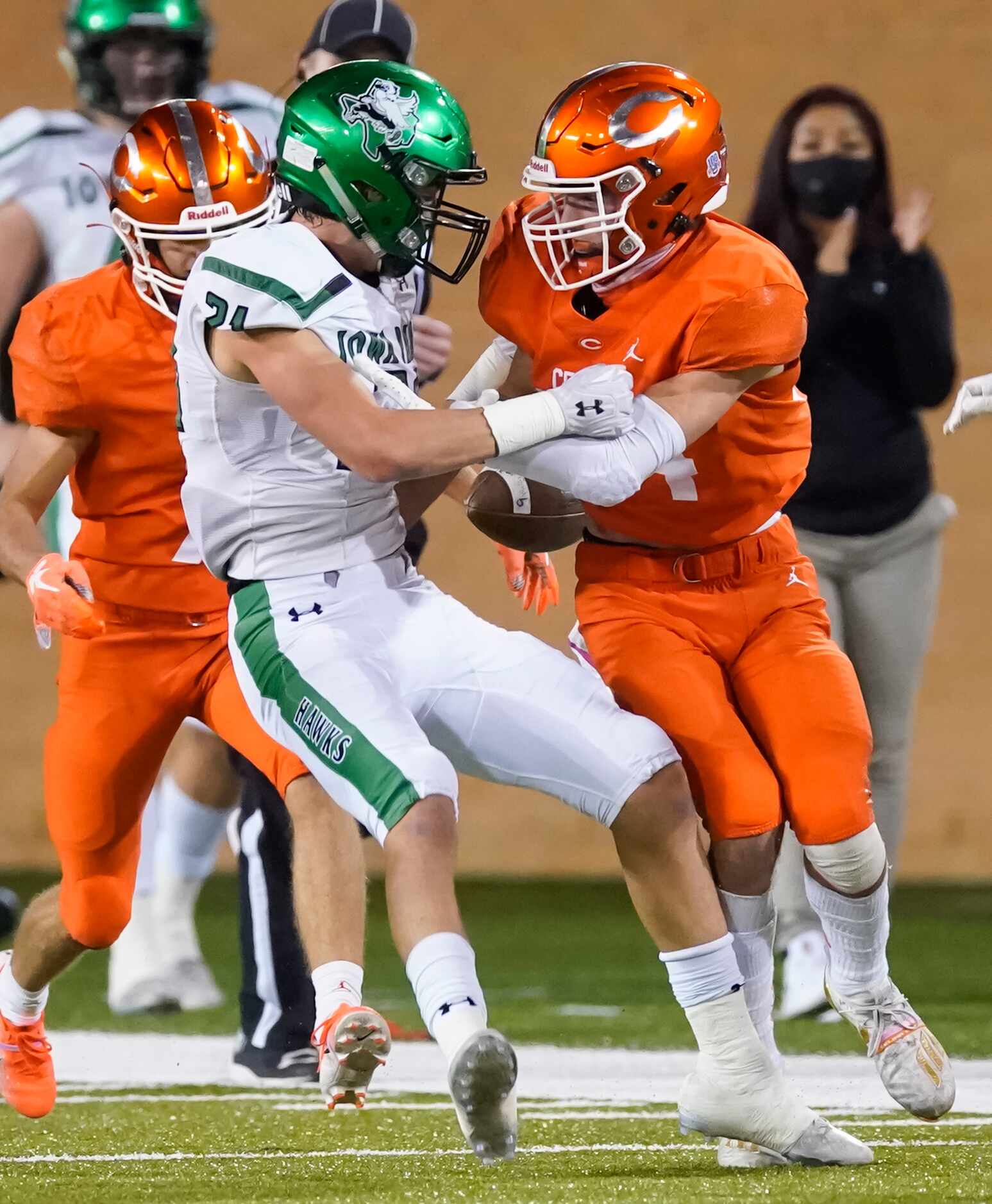 Iowa Park wide receiver Ty Cunningham (21) fumbles on a hit from Celina defensive back Cole...