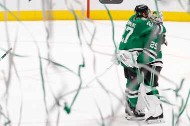 Dallas Stars left wing Mason Marchment (27) hugs Dallas Stars goaltender Jake Oettinger (29)...