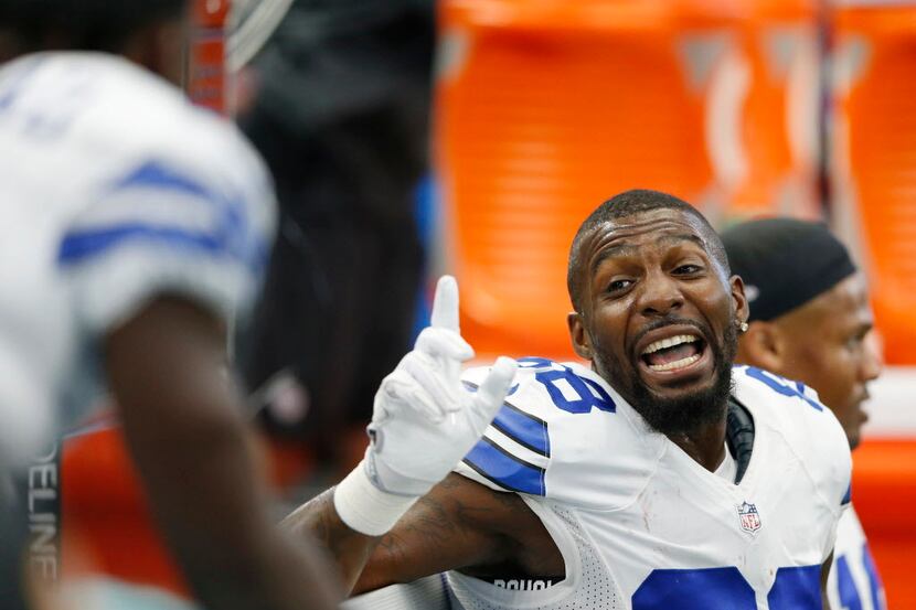 Dallas Cowboys Dez Bryant (88) talks to a teammate on the bench during the first half of...