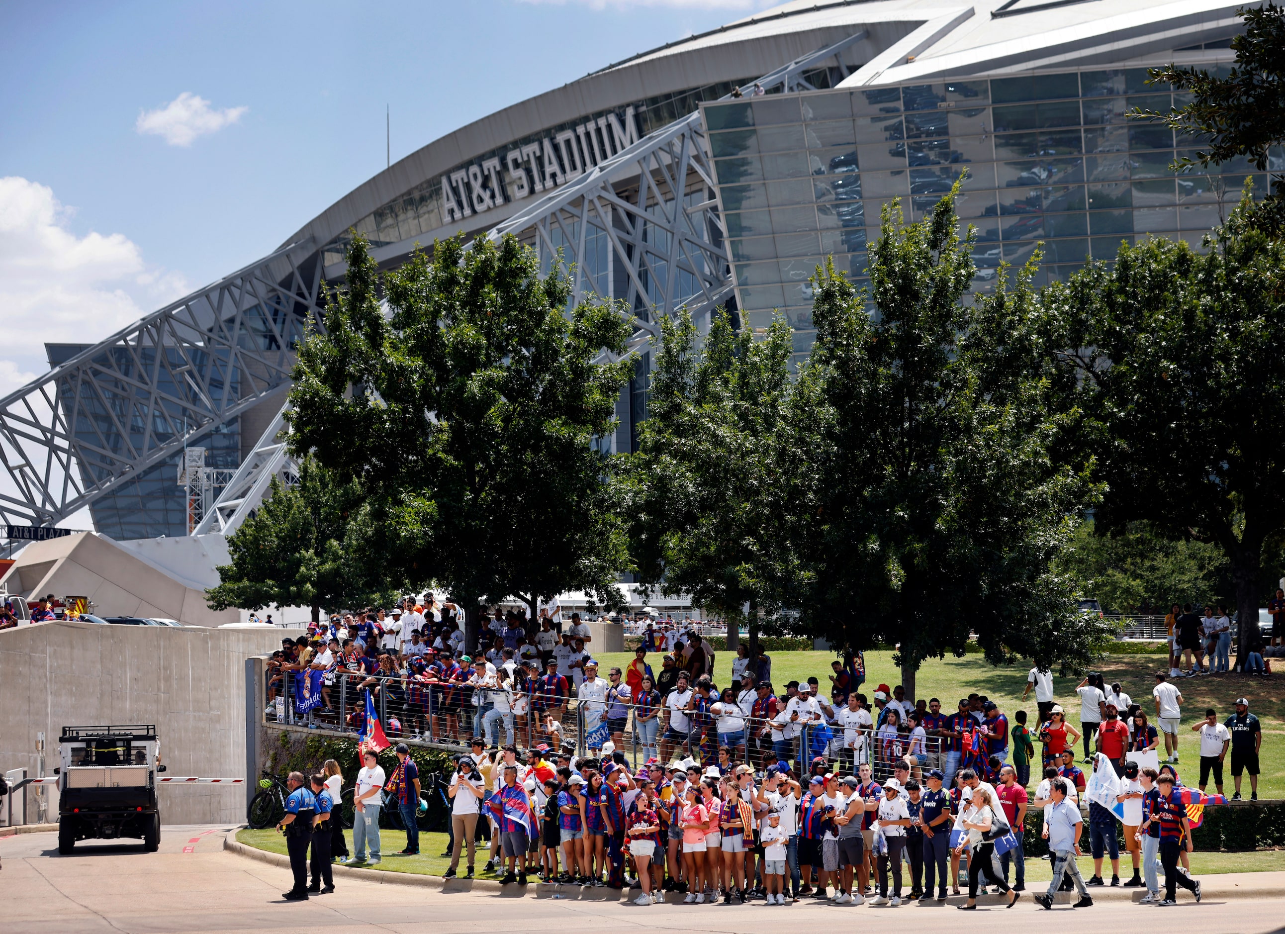 Real Madrid and Barcelona soccer fans wait for the team buses to arrive for their Soccer...