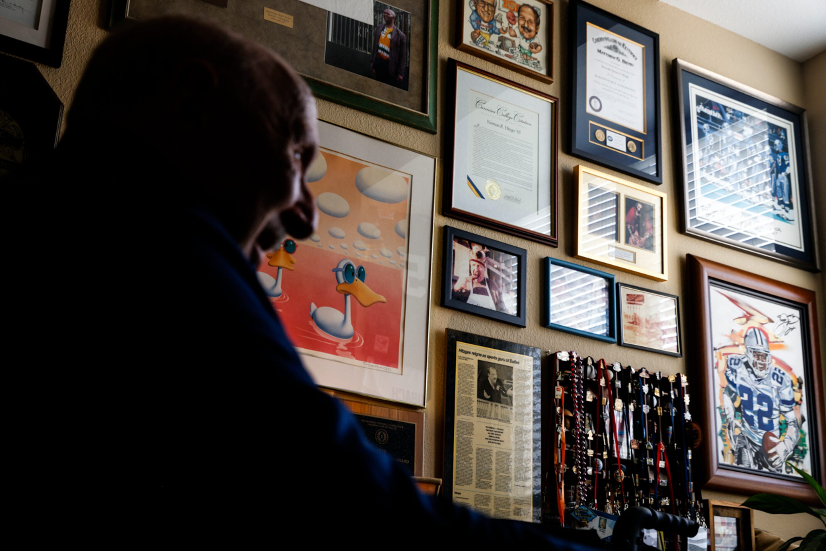 Memorabilia hangs on the wall of local sports radio legend 
Norm Hitzges’ office at his home...