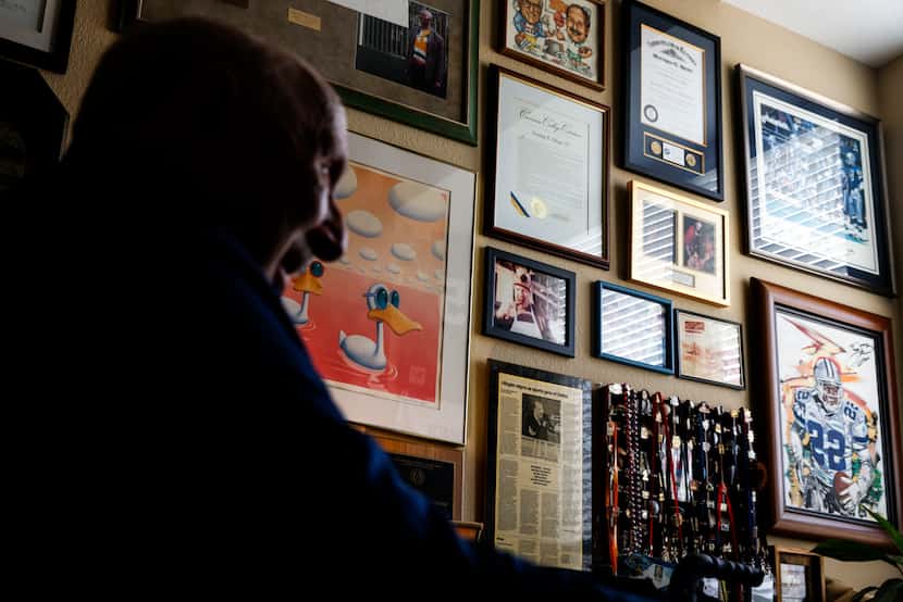Memorabilia hangs on the wall of local sports radio legend Norm Hitzges’ office at his home...